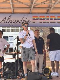 Speaker on stage at Alexandria Pride 2025