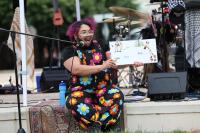 Speaker on stage at Alexandria Pride 2026