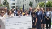 City staff, City Councilmembers, and HUD staff holding the check