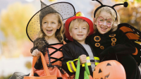 Three kids in Halloween costumes 