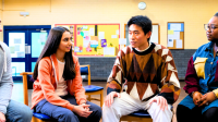 Diverse group of adults sitting in a half circle indoors engaged in conversation