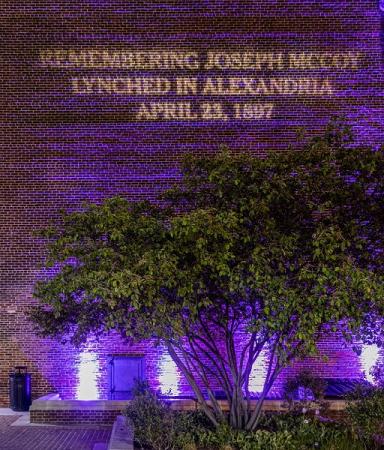 "Remembering Joseph McCoy, Lynched in Alexandria, April 23, 1897" projected on City Hall
