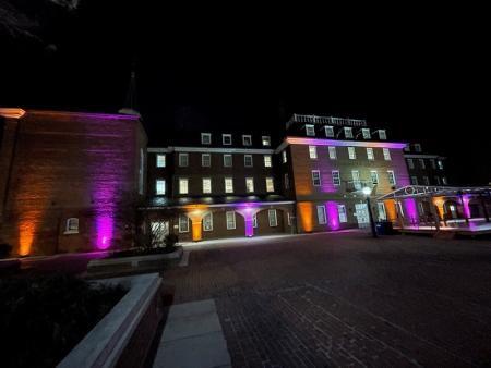 Purple and gold lights illuminating City Hall
