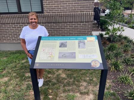 Woman standing next to sign
