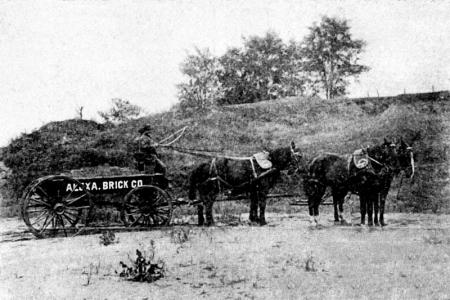 Horses pulling wagon with name of company