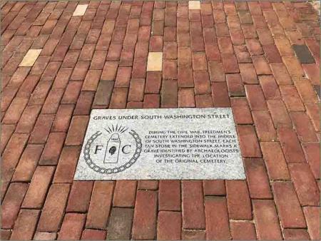 engraved marker in brick sidewalk