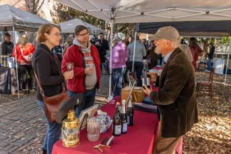 Two people at a cider tasting table