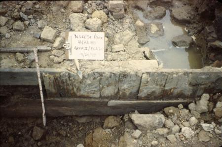 Archaeological excavation shows vertical wooden planks holding land in place. 