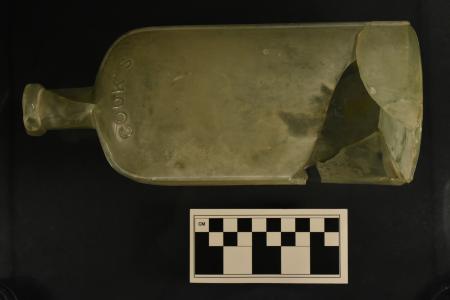 A partially mended glass bottle, approximately 20 cm tall