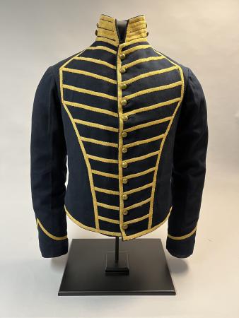 A blue fitted jacket with gold braid.