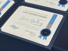 Certificate for Life Saving Award with blue ribbon and silver seal design