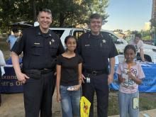Sheriff Casey and Captain Bridgerman Stand with Two Youth Community Members outside at an event
