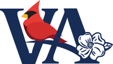 Cardinal sitting on the A in VA with a white flower  to the bottom right. 